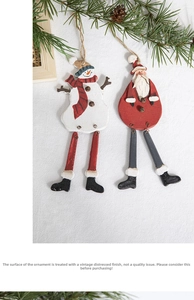 Detailed view of vintage wooden Santa and Snowman ornaments with rustic metal bells