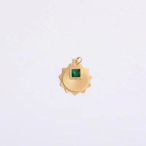 Detailed view of sun-shaped gold plated pendant featuring a square green zircon center stone