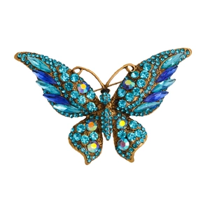 Elegant butterfly brooch with blue crystals and sparkling rhinestones on golden base