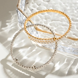 Detailed view of three-piece pave zircon bracelets in gold and silver luxury finish