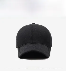 Close-up of a men's winter knit baseball cap with a decorative shield metal logo