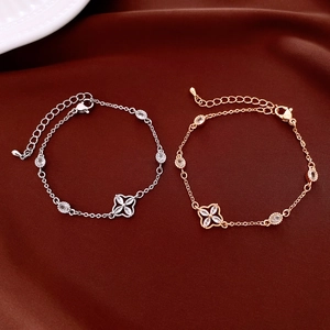 Detail of flower shaped bracelets with inlaid zircons in silver and rose gold finish