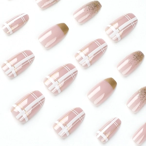 French style press-on nails with pink base, plaid patterns, and gold foil glitter accents