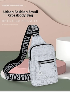Detail of the chic chest bag featuring neutral letter prints and wide nylon shoulder strap