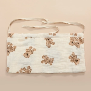 Detail of baby crib organizer with vintage bear print and cotton hanging straps
