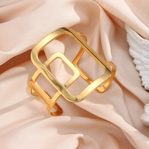 Modern 18K gold plated wide cuff bracelet featuring an abstract geometric hollow design