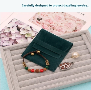 Detail of dark green suede envelope jewelry pouch with velvet ring display tray