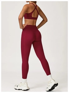 Detailed back view of deep wine red yoga set with cross-back sports bra and pocket leggings