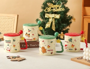 Detail of Christmas ceramic mugs with snowman and reindeer patterns including lids and spoons