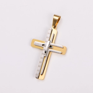 Macro detail of a two-tone gold and silver 3D metal cross pendant with fine texture