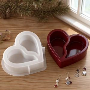 Detail of a dual-heart silicone mold and finished red glossy resin storage box
