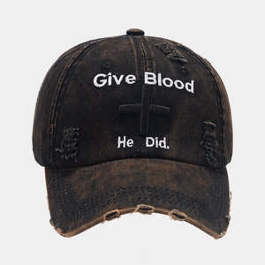 Close-up of distressed vintage baseball cap with Give Blood He Did embroidery and cross