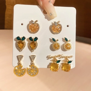 Close-up of a 6-pair mixed fruit earring set featuring apple, lemon, and pineapple motifs