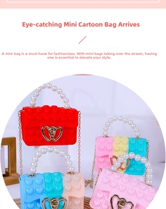 Detail of kids heart pop-it bag with large pearl handle and golden chain strap