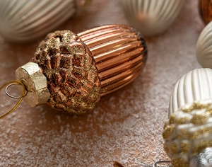 Detailed close-up of bronze acorn Christmas ornament with textured glitter finish