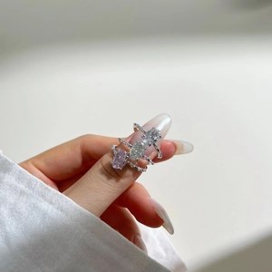 Macro shot of silver rings with pink and white oval cut ice flower cubic zirconia