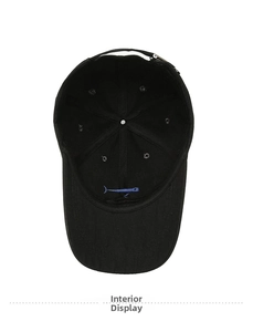 Macro shot of black cotton baseball cap interior with blue whale embroidery and adjustable strap