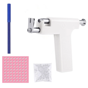 Detailed ear piercing kit including a professional white piercer tool and silver studs