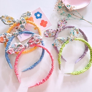 Close-up of floral bow hairbands in pink blue yellow and purple for girls