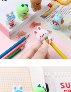 Close-up of cute cartoon silicone pencil toppers including bunny, bear and dinosaur shapes