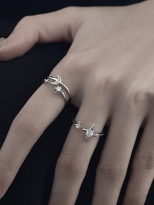 Detailed view of adjustable silver rings featuring sparkling moon and star zircon accents