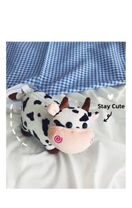 Detail of cute plush cow crossbody bag with soft black and white spots and zipper closure