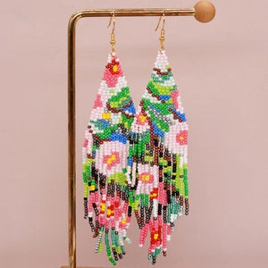 Handmade Bohemian tassel earrings with colorful seed beads in an abstract floral pattern