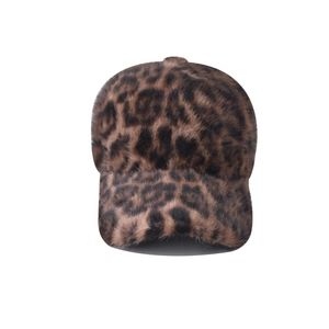 Close-up of leopard print baseball cap featuring fluffy faux fur texture for winter