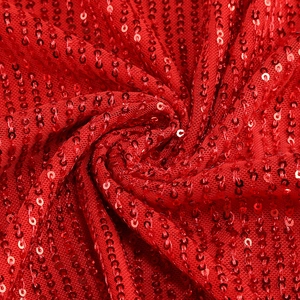 Detailed macro shot of red sequins fabric with vertical stripes for party dress
