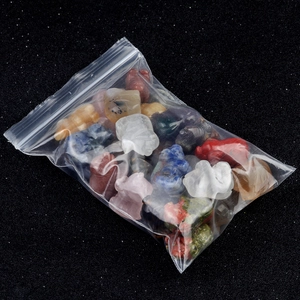 Mix of 20 colorful natural crystal pig figurines in a clear bag on a black background