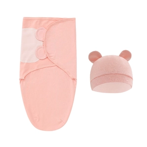 Pink newborn swaddle set with ear-designed sleep bag and matching cotton hat detail