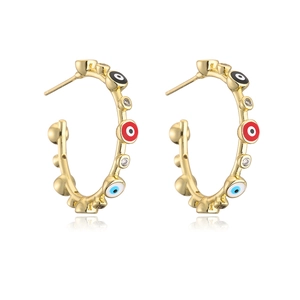 Detailed macro view of gold-plated hoop earrings with vibrant evil eye beads and zircons