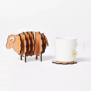 Creative sheep-shaped wooden coaster set with round mats and white ceramic cup detail