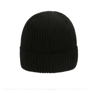 Close-up of black knitted beanie with vertical ribbed texture and wide folded cuff design