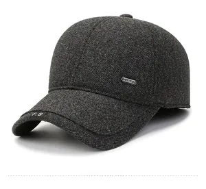 Close-up of deep gray men's winter cap showing textured wool fabric and metal side plate