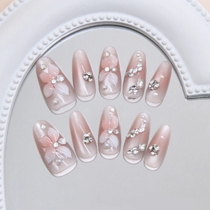 3D cat eye oval press-on nails with white lily petals, sparkling rhinestones and pearls