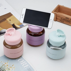 Three colorful chubby glass cups with PU leather sleeves and mobile phone holder lids