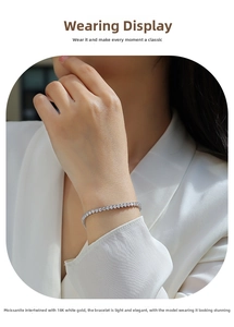 Close-up of elegant moissanite tennis bracelet in 18K white gold on a female wrist
