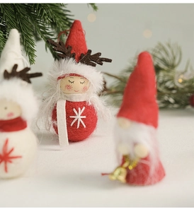 Détail de la poupée de Noël en feutre avec bois de cerf et flocon de neige brodé