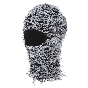 Distressed black and white knit balaclava with shaggy tassel details for outdoor warmth