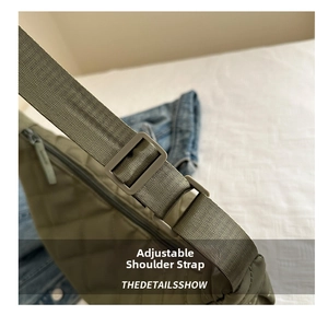 Detail showing the adjustable wide nylon shoulder strap on army green quilted bag