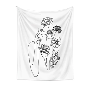 Detail of minimalist line art tapestry featuring female profile and floral patterns