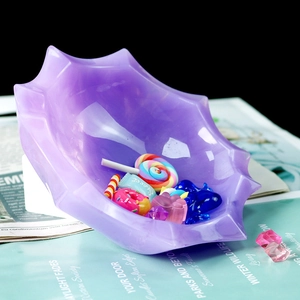 Top view of purple marble resin decagonal tray holding candy and crystal ornaments