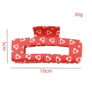 Red checkered hair claw clip with white heart pattern for Valentine's Day styling