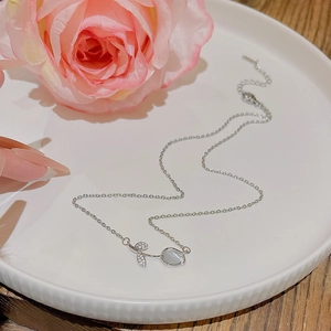 Detail of silver flower pendant necklace with clear crystals and delicate steel chain
