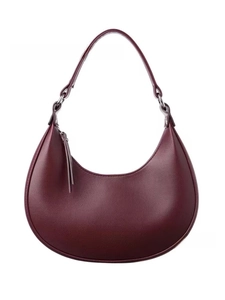 Detailed macro view of high-quality burgundy pebble leather texture on a hobo crescent bag