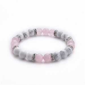 Macro view of 8mm white turquoise and rose quartz beaded yoga bracelet with silver spacers