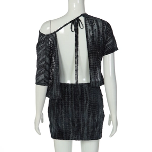 Detail of backless design and neck tie on a black textured pattern mini dress