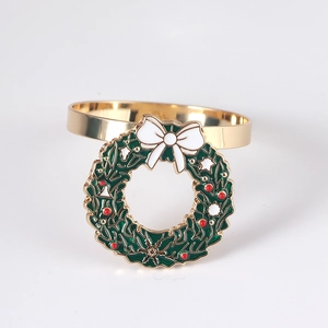 Golden Christmas wreath napkin ring with green enamel, red dots and white bow detail