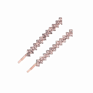 Close-up of pink rhinestone bobby pins with rose gold plating for wedding hairstyles